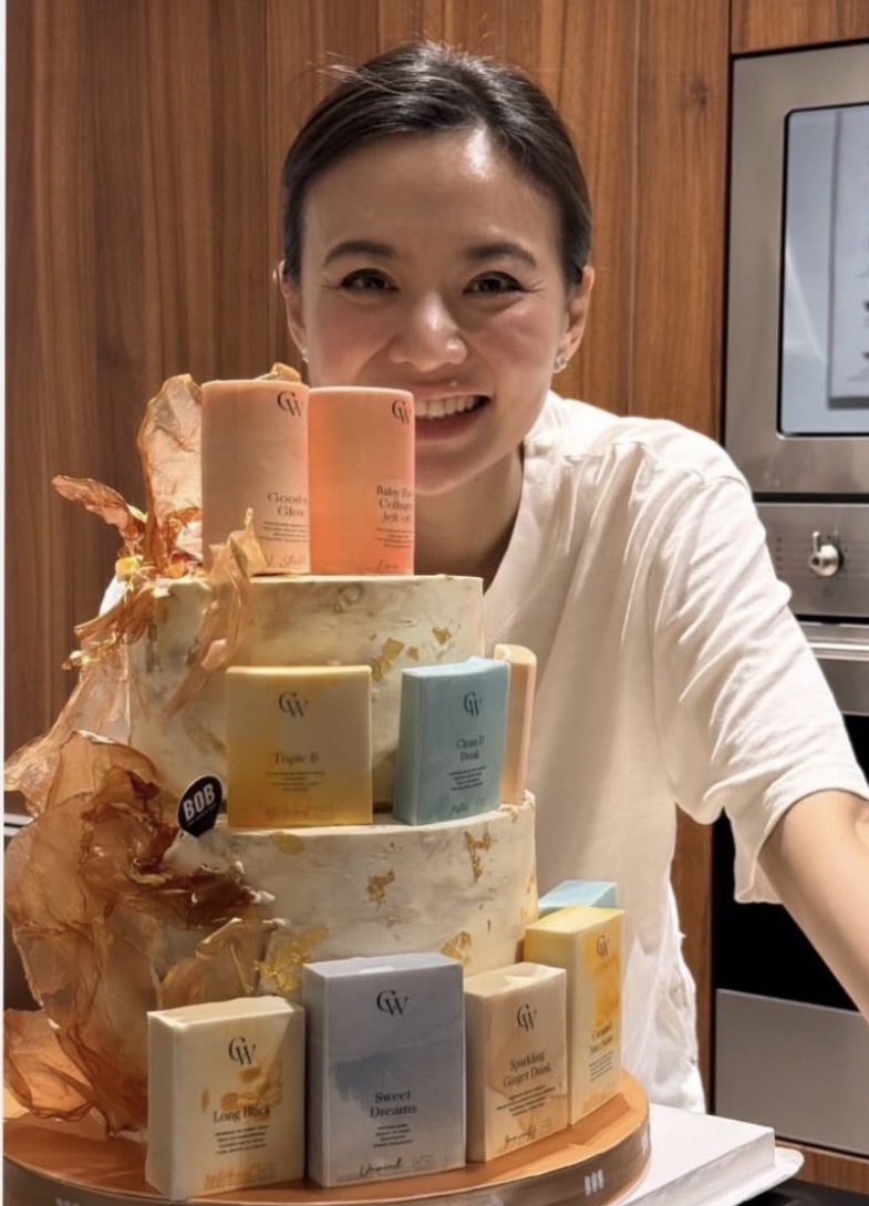 GW Health founder with the tiered product-topper corporate cake at the launch
