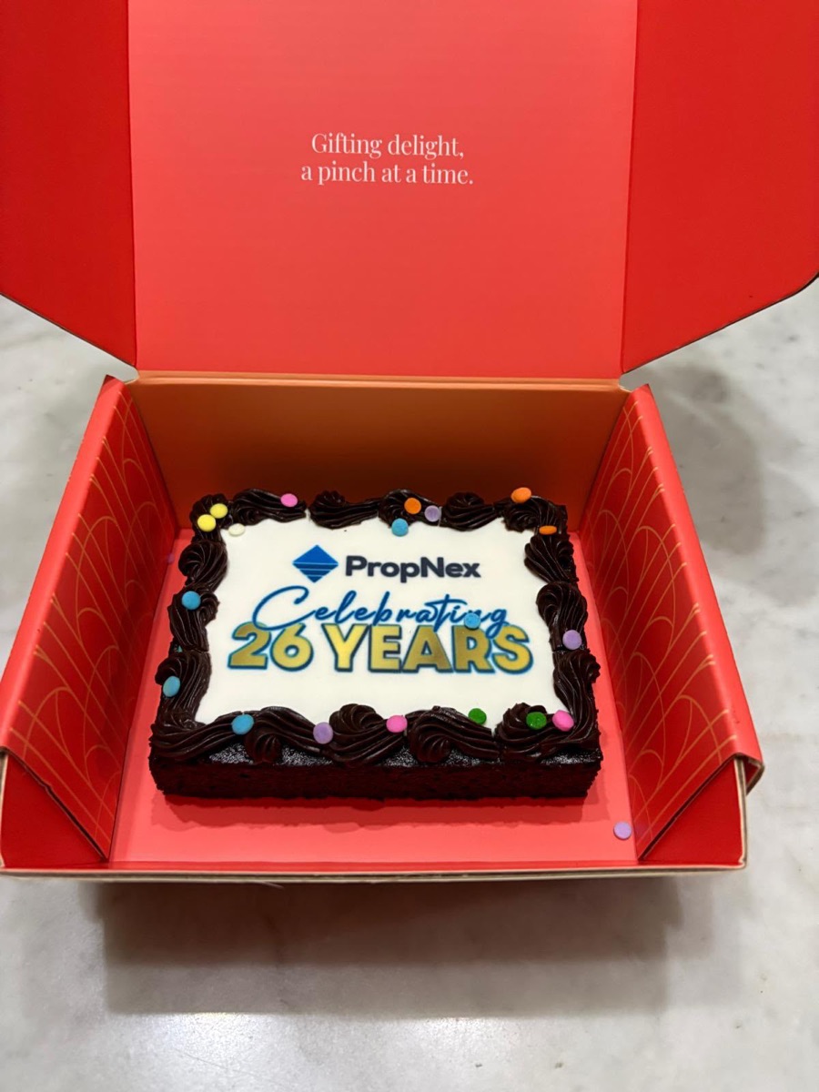 Close-up of the custom PropNex 26 Years brownie cake