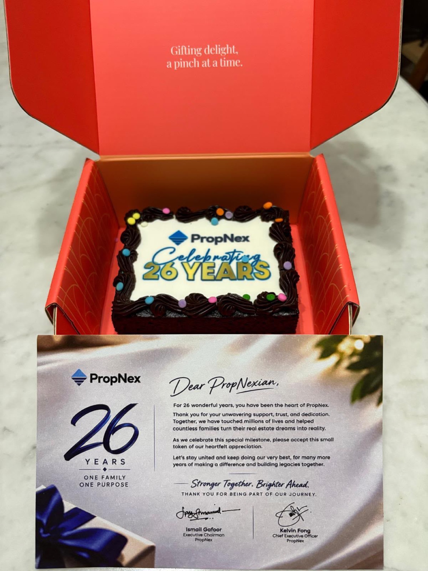 PropNex 26 Years anniversary brownie cake in a Bob the Baker Boy gift box with an appreciation card