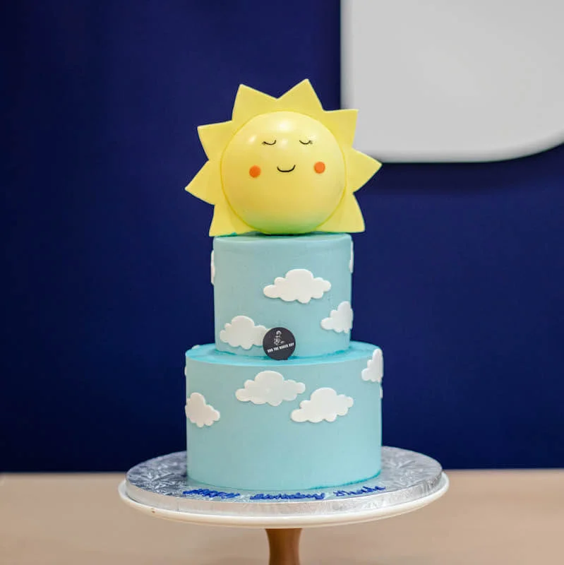 Sun themed baby shower cake wrap and cupcake toppers
