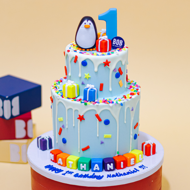 Frosty Winter Penguin Cake with Sprinkles and Presents