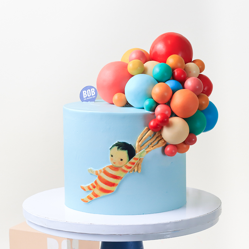 Little Toddler and Rainbow Balloons Cake