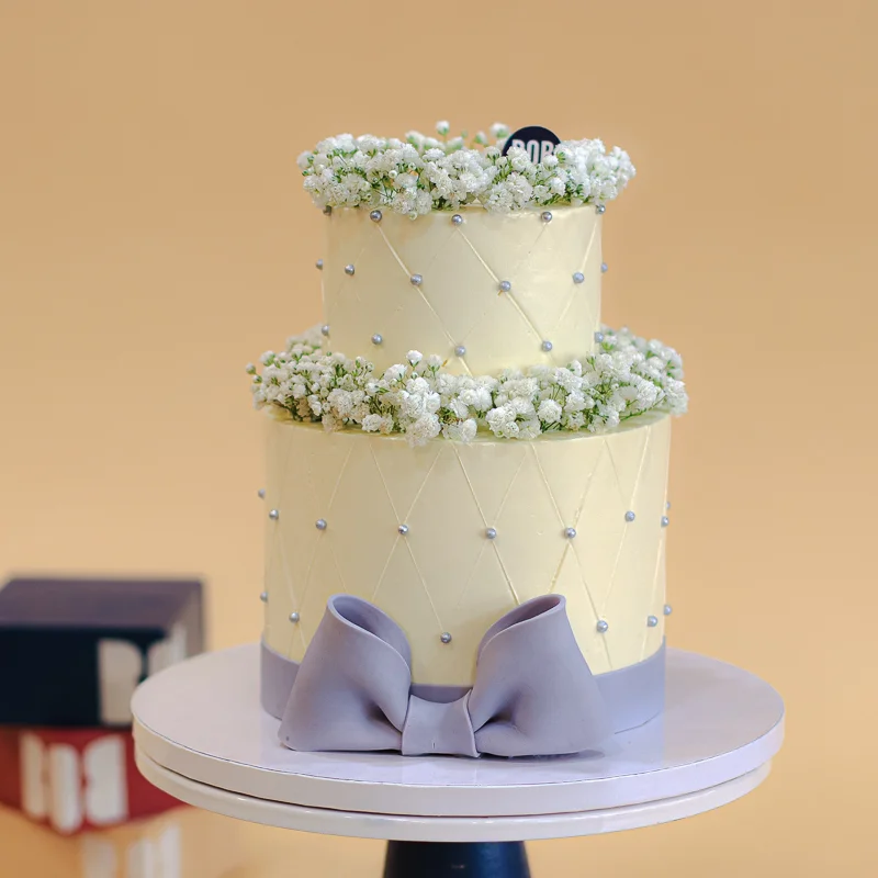 Dusty White Cake with Babies Breath and Satin Ribbon