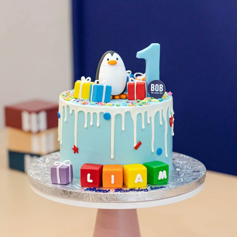 Frosty Winter Penguin Cake with Sprinkles and Presents